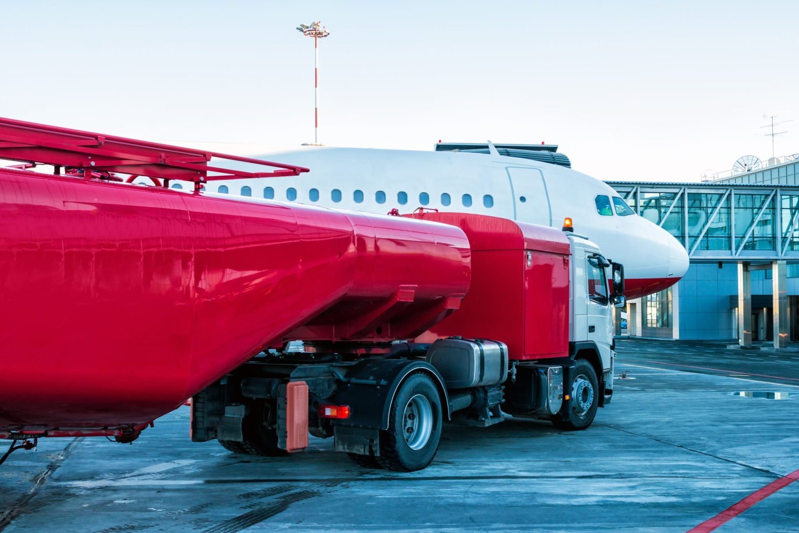 Fuel tanker refuelling an aircraft on the apron
