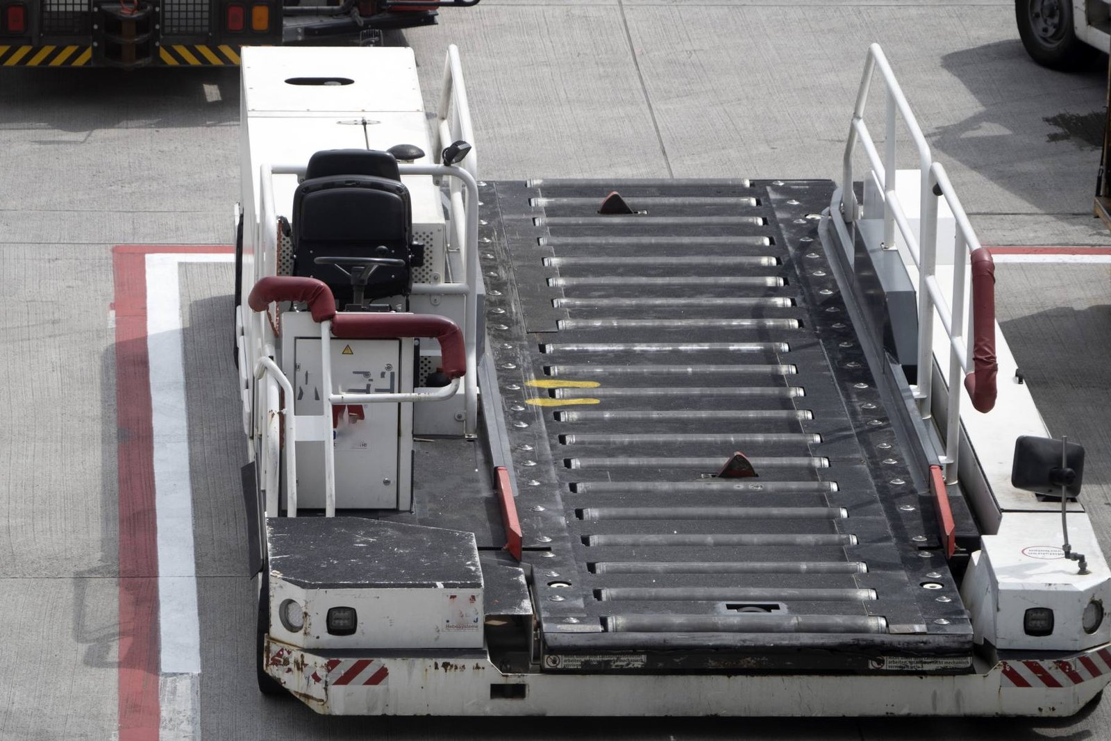Cargo loader working an aircraft at an airport station